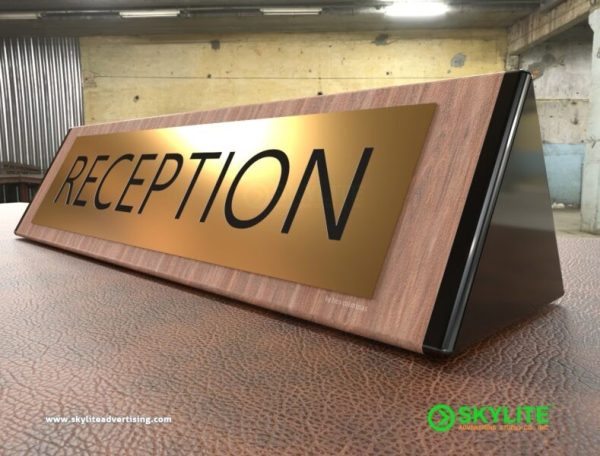 engraved brass reception sign on wood 1 1